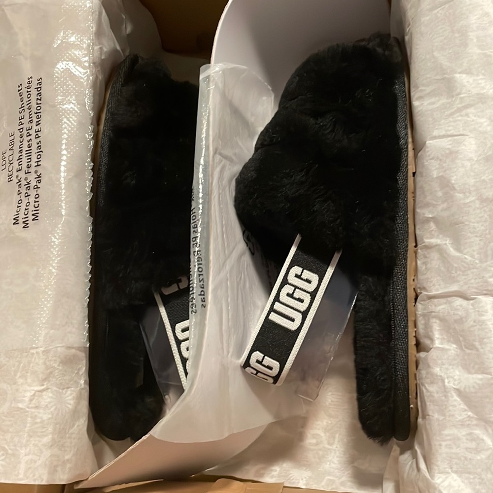 Brand new with kids Fluff UGG slides in black.